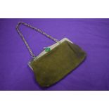 An early 20th century handbag, in moss green leather with green gem stones to stainless steel