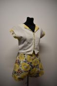 A 1940s two piece sun set in textured cotton, comprising shorts with yellow floral design and side