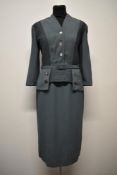 A 1950s teal green day dress, having ribbed detail to bodice and top of skirt, belt to waist and