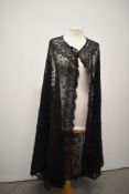 A Victorian long black tulle lace shawl, some areas of wear, however a beautiful piece.