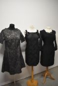 Three 1960s black party dresses, medium to larger sizes.