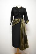 A vintage 1940s evening dress in black wool having olive green satin sash, collar and cuffs, fancy