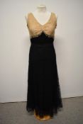 A 1930s bias cut cream and black lace evening dress, having silk liner and belt (press studs