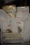 A selection of vintage bed linen, including unused sheets in packaging, pillow slips and baby