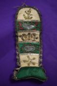 A 19th century green and cream silk hussif, having extensive metal and beaded decorations and