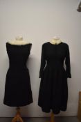 A 1940s black wool day dress, having white fur collar and self covered buttons to front, with