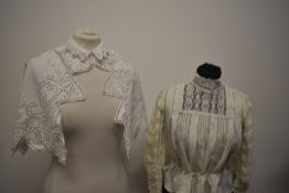 An Edwardian silk blouse, having high lace collar and tucks to sleeves, sold with a white cotton cut
