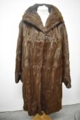 A vintage mahogany coloured fur coat, having deep shawl collar and wide cuffs.