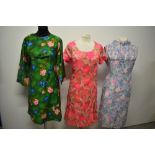 Three vintage 1960s dresses, in bright and cheerful prints.