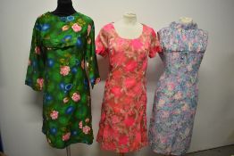 Three vintage 1960s dresses, in bright and cheerful prints.