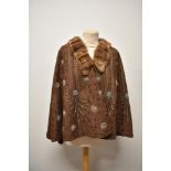 A vintage Art Deco beaded cape, having beige felt ground with blue, bronze and clear beads, fully