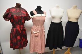 A 1950s cotton day dress in red with white and black pattern and cream accents to bodice and