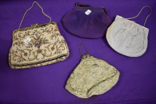 Four vintage evening bags, including purple crepe bag with diamante detail and needlepoint example.