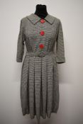 A 1950s day dress of medium weight fabric, having dog tooth pattern with shawl collar, large