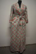 A 1940s/50s cotton housecoat, having bright rose pattern on grey striped white ground, with shoulder