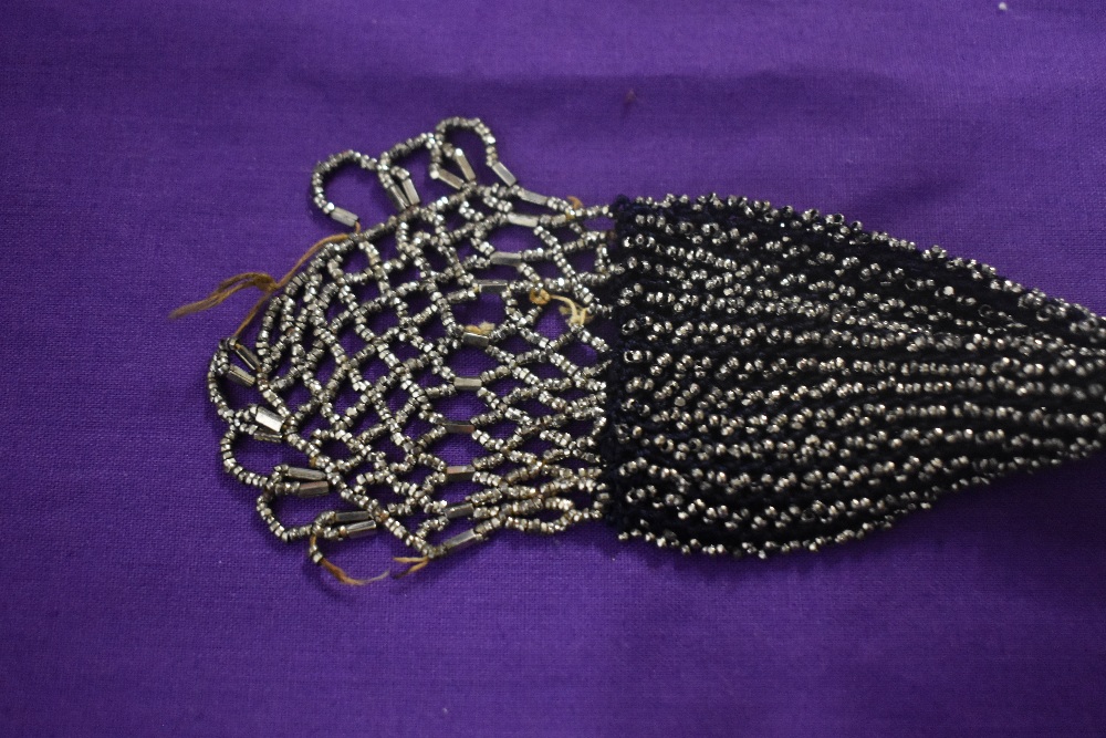 A 19th century misers purse, having steel bands and silver tone beading throughout. - Image 2 of 3