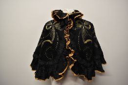 A Victorian black felt beaded and sequinned cape, having ruffles to front and neckline in black
