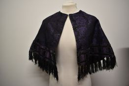 A Victorian Silk Brocade capelet, having floral motifs, crosshatched purple velvet and bands of