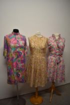 Three 1960s day dresses in pastel colours.