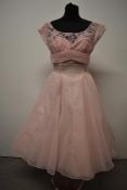 A stunning 1950s pale pink evening gown, having illusion bust with lace overlay,stiffened