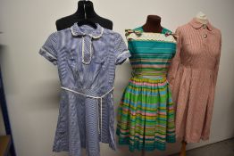 Two 1950s dresses, including striped cotton day dress with bold striped pattern and pleated