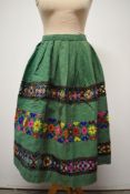 A medium weight vintage skirt having colourful wool embroidered designs.