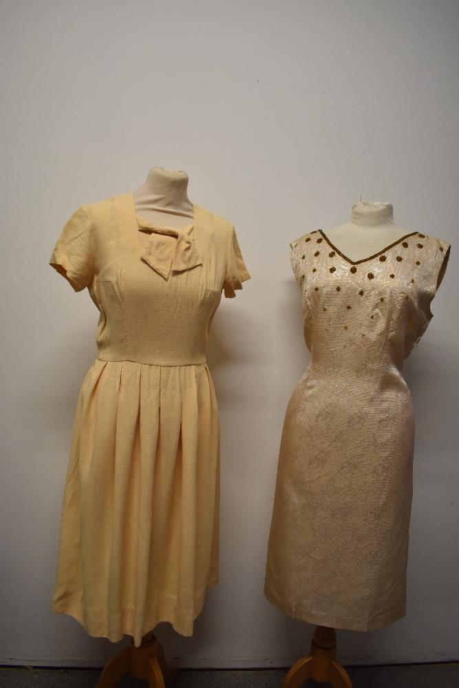 A 1950s buttermilk textured cotton day dress with tie detail to bodice, pleated skirt and cap