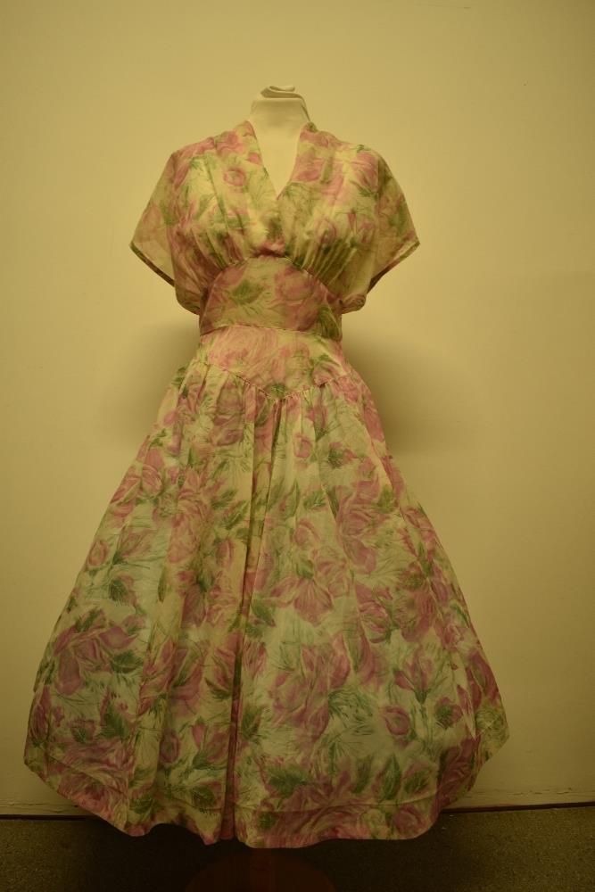 A late 1940s/early 1950s semi sheer day dress, having floral pattern, larger size.