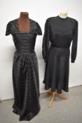 A 1950s evening gown with shawl collar and a 1940s day dress having button decoration to back and
