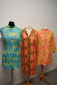 Three 1960s brightly patterned dresses, in medium to larger sizes.