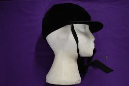 An early 20th century black velvet cap.
