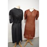 A 1940s/50s black day dress with lace inserts to bodice and sleeves and a russet semi sheer dress,