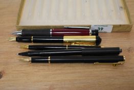 Two fountain pens, two ball point pens and a fibre tip. A Sheaffer fashion fountain pen in matt