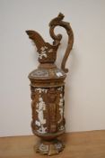 A 20th century chalk ware ewer, having moulded classical figures and gargoyle to handle.