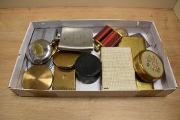 A selection of vintage compacts, cigarette cases, two stirrup cups and two hip flasks.