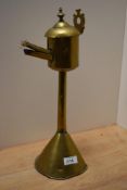 A primitive antique brass taper lighter or similar.