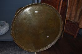 A large Indian brass charger or table top, measuring 75cm in diameter