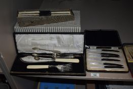 An assorted collection of vintage cutlery sets, with mother of pearl and ivorine handles