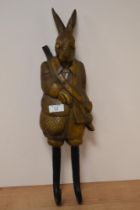 A modern coat hook in the form of a hare garbed in shooting attire.