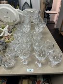 An assorted collection of cut glassware, whisky tumblers, wine glasses, and brandy balloons