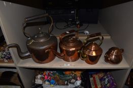 An assorted group of 19th/20th Century copper kettles, the largest measuring 36cm tall