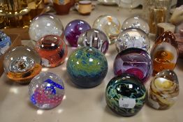 An assorted collection of art glass paperweights, by Caithness glass, and others