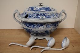 A large tureen, sat aloft raised foot having handles to sides, sold with three ceramic ladles. AF.