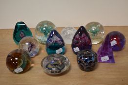 Twelve paperweights, many Caithness, including controlled bubble and Adrian Sankey paperweight of