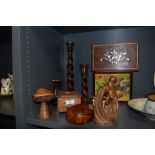 A selection of treen, including turned mushroom, carved figure, twist stem candlesticks and inlaid