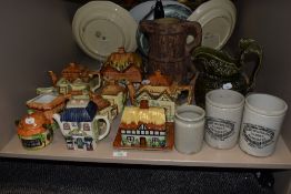 A group of novelty cottage ware teapots, an Arthur Wood green glaze jug, and three stoneware jars
