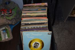 An assorted collection of vintage records, including Fats Domino, Chris Rea, Neil Diamond, War of