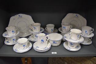 A collection of Art Deco Victoria bone china cups and saucers, plates, jug and cake plates, having