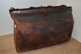 A vintage leather Gladstone bag..