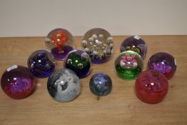 A selection of paperweights, including Caithness inferno and splashdown, various colours and